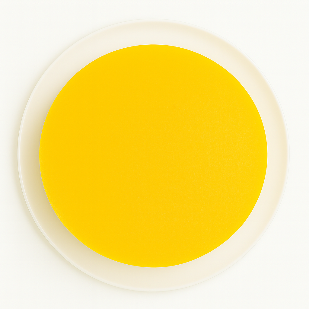 Top-down view of a round mango and apricot cheesecake on a white plate, showing the smooth, vibrant yellow fruit topping covering the entire surface of the cake, set against a white background.