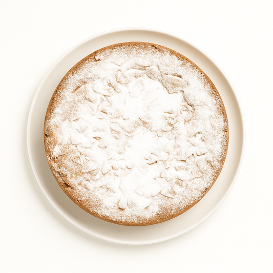 A top-down view of a round cake with a golden-brown crust, generously dusted with powdered sugar, sitting on a white ceramic plate against a white background.
